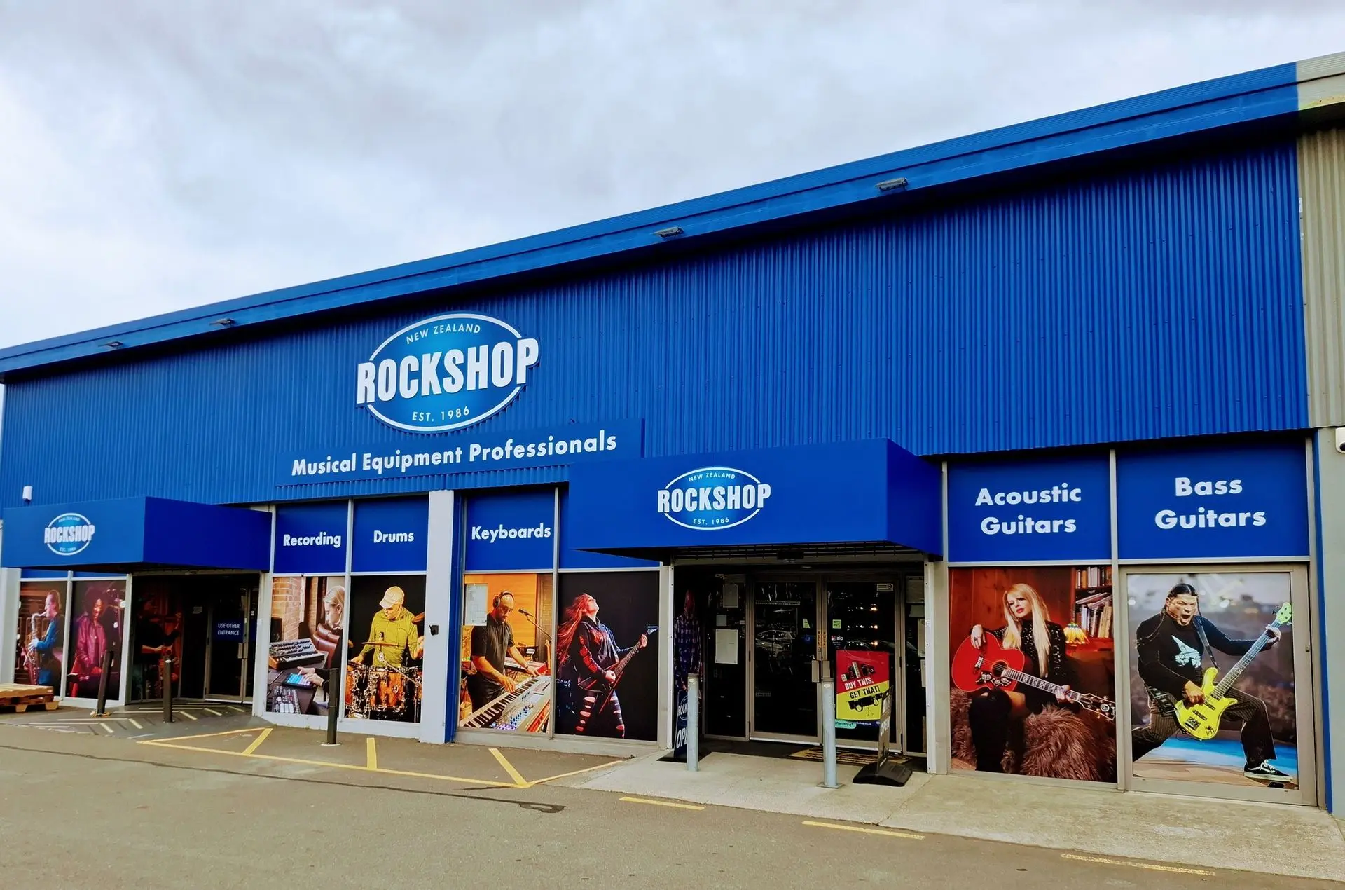 Exterior signage and window vinyl branding for the Rockshop by Displayworks.
