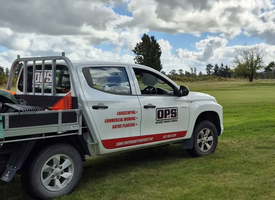 Part coverage vehicle wrap for Outright Property Services flat deck ute - with services and contact details.