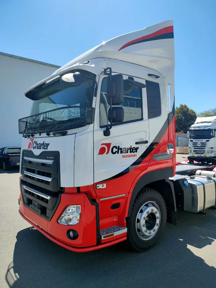 Truck cab branding in red and white for New Zealand logistics transport company Charter