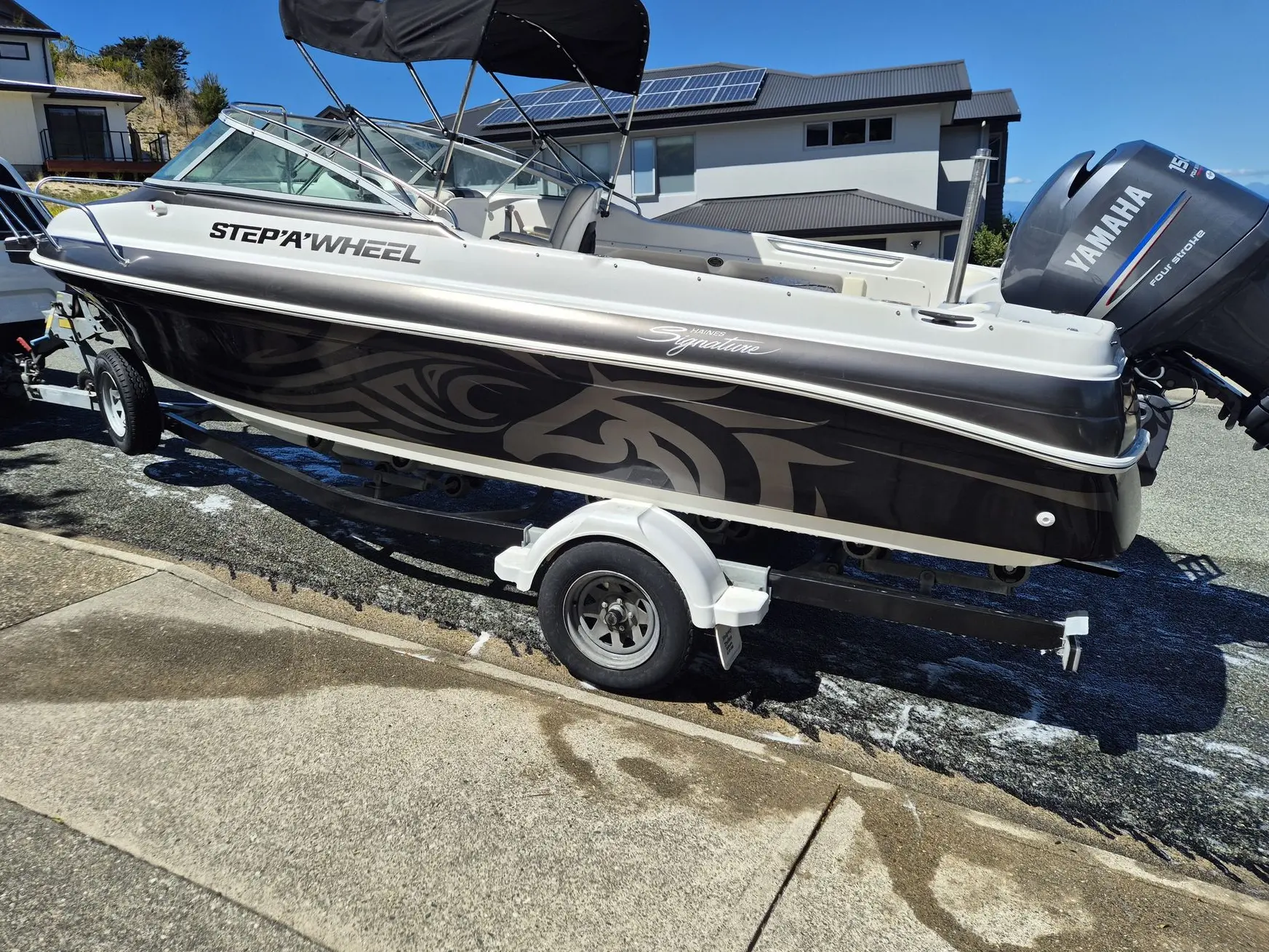 Boat signage with name graphics and pattern wrap on a trailer boat.