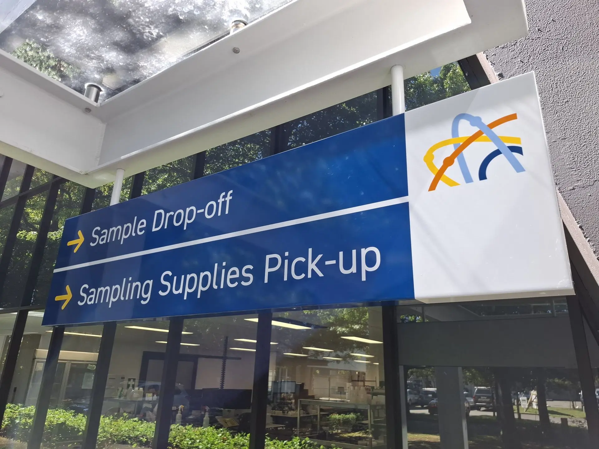 Hanging directional signage for healthcare site, directing drop offs.