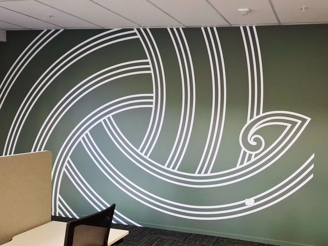 A bold maori themed design is printed on this wall at Canterbury University.