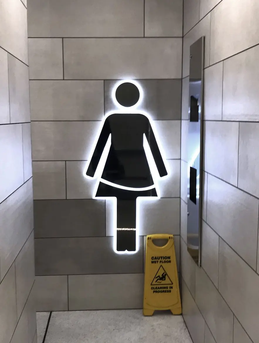 Illuminated female bathroom signage 